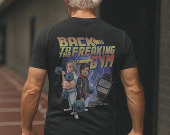 May include: Black t-shirt with a graphic featuring two cartoon characters lifting weights, with the text "BACK TO THE FREAKING GYM." The design includes a digital watch and the words "COMING BACK STRONGER BETTER FASTER."