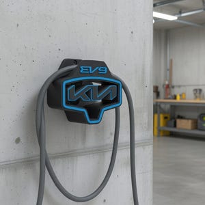 May include: Black and blue EV9 charger mounted on a concrete wall. The charger features the Kia logo and the text "EV9" in blue. A gray charging cable is connected to the charger.