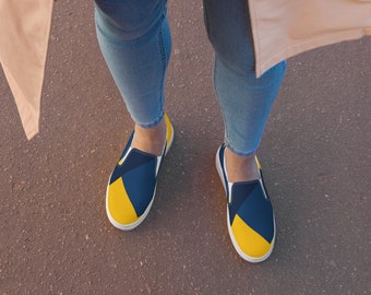 May include: A pair of blue and yellow slip-on shoes with a geometric pattern.