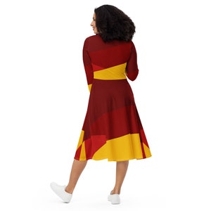 May include: A red and yellow geometric print midi dress with long sleeves. The dress has a fitted bodice and a flared skirt.