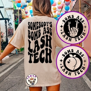 May include: A beige t-shirt with the text "Somebody's Bomb Ass Lash Tech" printed in black. The shirt is being worn by a person. There are two black and white circular designs with the text "Bomb Ass Lash Tech" printed in white. One design features a skeleton hand making a rock and roll hand gesture. The other design features a peach with hearts.