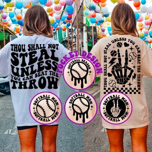 May include: Two white and beige t-shirts with a softball theme. The white shirt has the text "Thou Shall Not Steal Unless You Can Beat The Throw" in black. The beige shirt has a skeleton hand with a peace sign and the text "Thou Shall Not Steal Unless You Can Beat The Throw". Both shirts have a softball graphic with the text "Softball Mom" and "Softball Season".