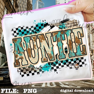 May include: White t-shirt with the word "AUNTIE" in a distressed, turquoise and brown design. The design includes a checkered pattern, turquoise paint splatters, and a small illustration. The text "FILE: PNG" and "digital download" are at the bottom.