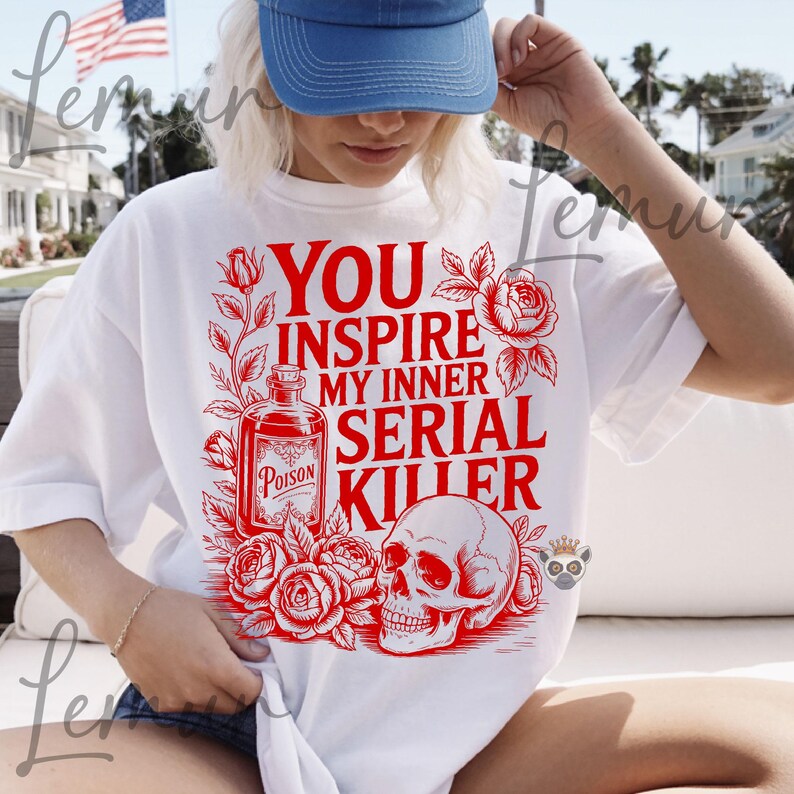 May include: White t-shirt with a red graphic that reads "YOU INSPIRE MY INNER SERIAL KILLER." The design includes a poison bottle, roses, and a skull. The shirt is a casual, oversized fit.