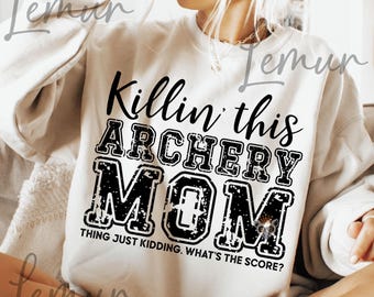 May include: White sweatshirt with black text that reads "Killin' this ARCHERY MOM THING JUST KIDDING. WHAT'S THE SCORE?"