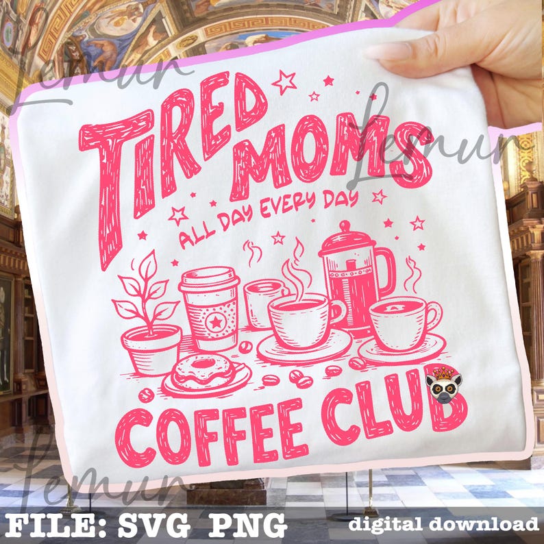 May include: White tote bag featuring a pink graphic with the text "Tired Moms Coffee Club" and coffee-themed illustrations. The design includes a coffee pot, cups, a donut, and a plant. The text "All Day Every Day" is also included.