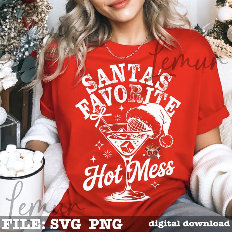 May include: Red t-shirt with a white graphic that reads "Santa's Favorite Hot Mess." The graphic includes a cocktail glass with a Santa hat, ice cubes, and stars. The shirt is short-sleeved.