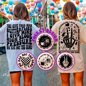 May include: Two t-shirts with a pocket design featuring a black and white graphic with the text "We are not the same" and a heart with a checkered pattern. The text on the shirts reads "You give your man butterflies I give mine high blood pressure we are not the same".