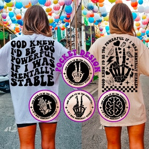 May include: Two white t-shirts with black text and graphics. The front of the shirt says "God knew I'd be too powerful if I was mentally stable". The back of the shirt has a graphic of a skeleton hand making a peace sign with the text "God knew I'd be too powerful if I was mentally stable".