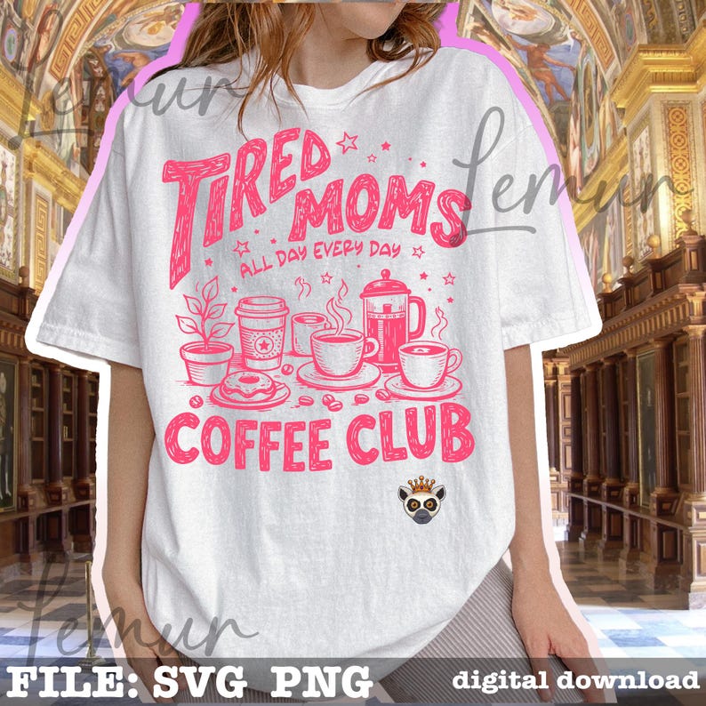 May include: White t-shirt featuring the pink text "Tired Moms Coffee Club". The design incorporates illustrations of coffee cups, a coffee pot, a donut, and a plant. The phrase "All Day Every Day" is also included in the design.