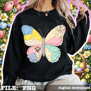 May include: Black sweatshirt featuring a colorful patchwork butterfly design. The butterfly has wings in shades of blue, yellow, pink, and green. The butterfly's body is blue and the design includes a small lemur wearing a crown. The words "FILE: PNG" and "digital download" are at the bottom.