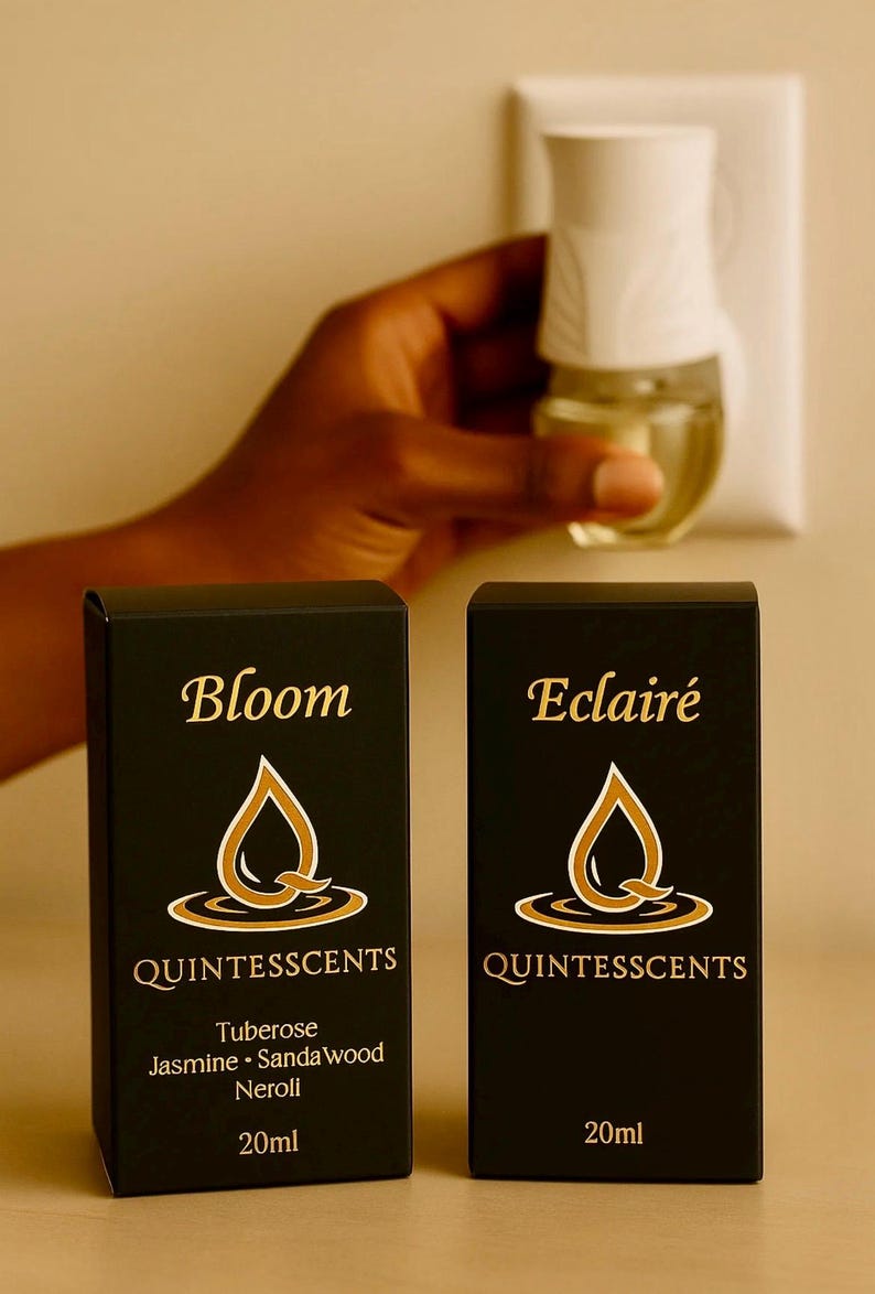 May include: Two black boxes with gold lettering and a matching air freshener. The boxes read "Bloom" and "Eclair&eacute;" with the brand "Quintesscents". The "Bloom" box lists Tuberose, Jasmine, Sandalwood, and Neroli. Each box contains 20ml.