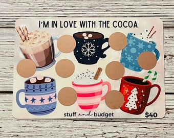 May include: A gift card for $40 to "stuff and budget" with a design featuring various mugs of hot cocoa. The text "I'm in love with the cocoa" is at the top of the card.