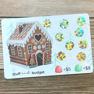 May include: A light blue card with a gingerbread house illustration, surrounded by holographic circles and Christmas tree designs. The text "stuff and budget" is at the bottom. A red and green candy are shown with prices.