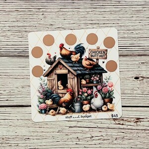 May include: A colorful illustration of a chicken coop with a sign that reads "Chicken Butt Hut". The coop is surrounded by chickens, flowers, and a watering can. The image is on a white background with a brown and gold checkered pattern.