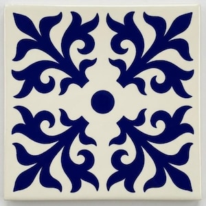 May include: A square ceramic tile featuring a glossy off-white base with a deep blue symmetrical floral pattern. The design consists of four stylised leaf-like motifs radiating from a central solid blue circle, creating a balanced geometric look.