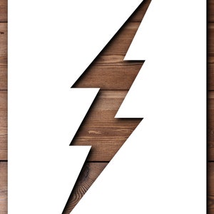 May include: A white lightning bolt shape cut out of a piece of wood. The wood is a dark brown colour and has a natural grain pattern.