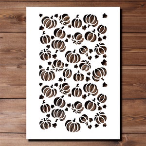 May include: White stencil featuring a repeating pattern of black pumpkins and leaves. The stencil is ideal for creating a fall-themed design on a variety of surfaces.