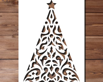 May include: White paper cut-out of a Christmas tree with a star on top. The tree is decorated with intricate, symmetrical patterns.