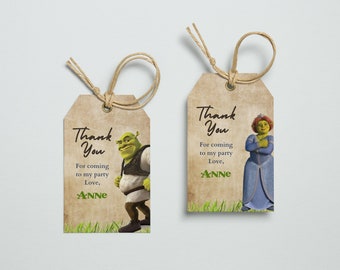 May include: Two thank you tags with a green ogre and a princess from the movie Shrek. The tags are brown and have the text "Thank You" and "For coming to my party Love, ANNE".