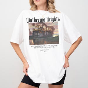 May include: White oversized t-shirt with a graphic print of a landscape scene and the text "Wuthering Heights" above the image. The text below the image reads "Whatever our souls are made of, his and mine are the same." and "Emily Bronte".