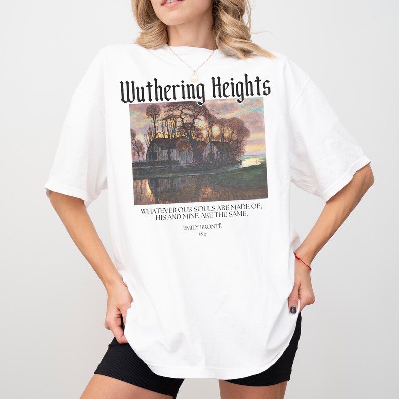 May include: White oversized t-shirt with a graphic print of a landscape scene and the text "Wuthering Heights" above the image. The text below the image reads "Whatever our souls are made of, his and mine are the same." and "Emily Bronte".