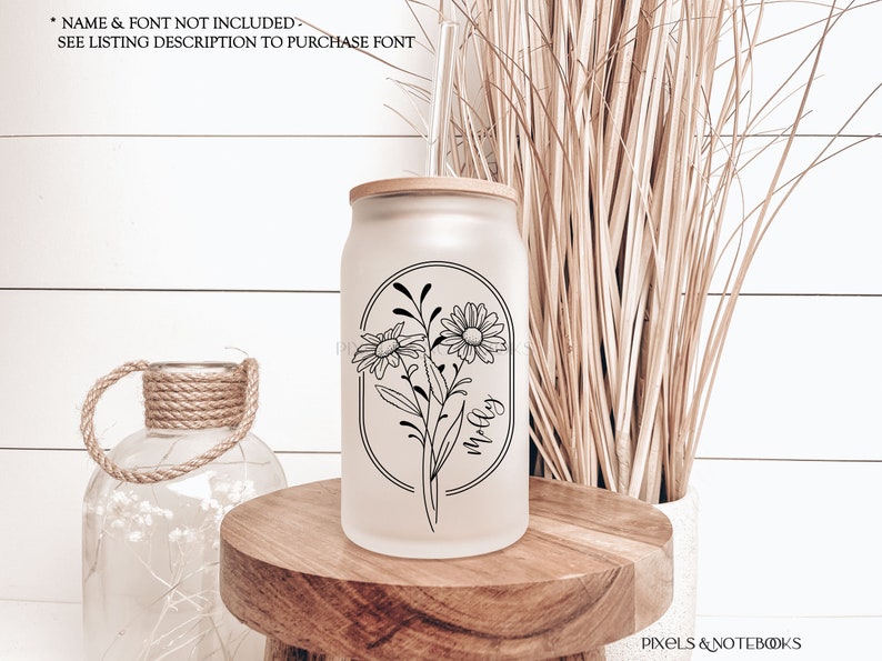 May include: A frosted glass tumbler with a bamboo lid and a black and white graphic of daisies with the word "molly" written inside a circle.