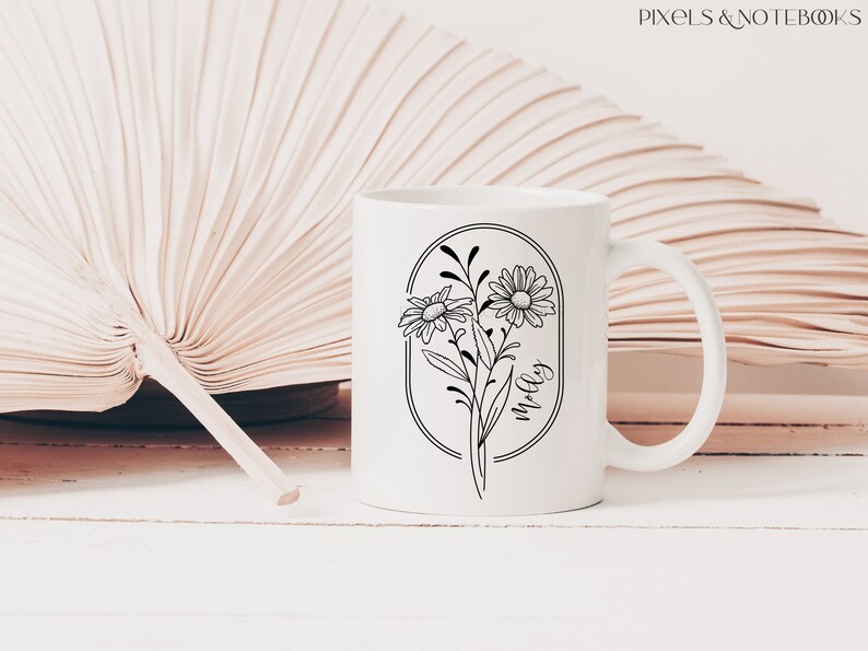 May include: White ceramic mug featuring a black outline of flowers and the word "Molly" within an oval.
