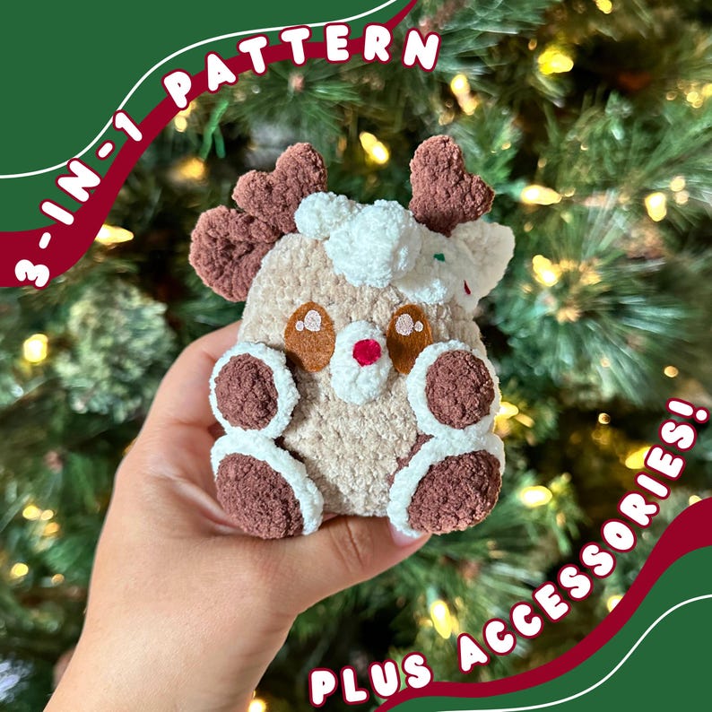 May include: A crocheted reindeer plush toy with brown antlers, white fur, and brown accents. The toy is being held in a hand against a green and red background with the text "3-in-1 PATTERN PLUS ACCESSORIES!"