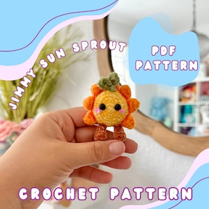 May include: Crochet pattern PDF for a cute amigurumi sun sprout with a yellow and orange body, green leaves, and brown legs. The pattern is called "Jimmy Sun Sprout".