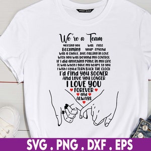 May include: White t-shirt with a black graphic design that says "We're a Team" and includes a quote about love and a couple holding hands. The graphic also includes red hearts.