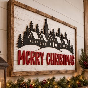 May include: A rectangular wall sign with a dark wood frame and a white wood-plank background. It features a black silhouette of a village with snow-covered roofs and pine trees, with the red text MERRY CHRISTMAS displayed prominently below.