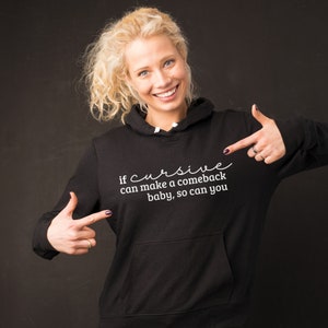May include: Black hooded sweatshirt with white text that reads "if cursive can make a comeback baby, so can you".