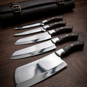 May include: A set of five stainless steel kitchen knives with dark wooden handles and a brown leather carrying case. The knives include a cleaver, chef's knife, and paring knife, all arranged on a wooden surface.