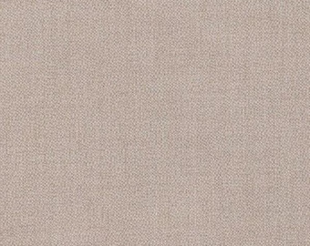 May include: A close-up shot of a textured fabric in a neutral beige color. The fabric has a woven appearance, with a subtle pattern of small, interwoven threads. The overall effect is a soft, muted texture.