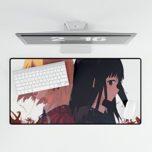 May include: A mousepad featuring an anime illustration of two girls with long hair. The girl on the left has blonde hair and is wearing a red and white outfit. The girl on the right has black hair and is wearing a blue and white outfit. The mousepad is on a white surface with a computer monitor above it.