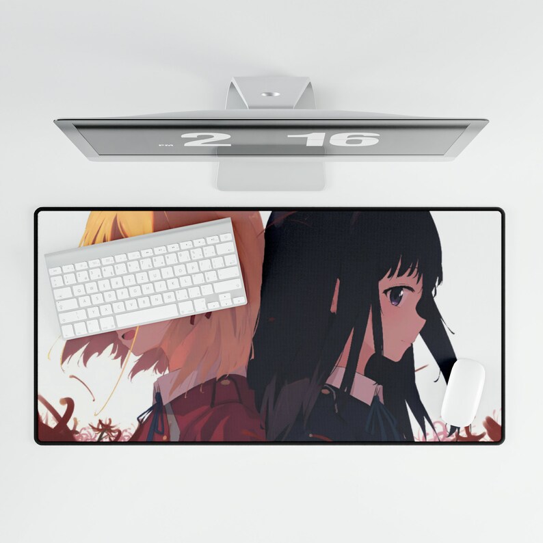 May include: A mousepad featuring an anime illustration of two girls with long hair. The girl on the left has blonde hair and is wearing a red and white outfit. The girl on the right has black hair and is wearing a blue and white outfit. The mousepad is on a white surface with a computer monitor above it.
