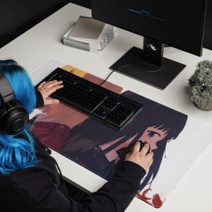 May include: A white and black anime-style mousepad with two female characters. The mousepad features a black keyboard and a person's hand using a computer mouse.