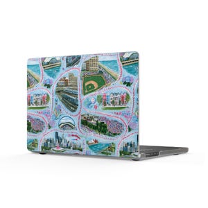 May include: A laptop skin featuring a light blue background with a repeating pattern of pink baseball stitching lines. The design includes various illustrated scenes of Chicago landmarks, including the skyline, a baseball field, and the Cloud Gate sculpture.