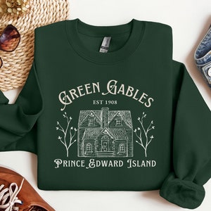 May include: A dark green sweatshirt with a white graphic design of a house with the text "Green Gables Est 1908 Prince Edward Island".