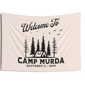 May include: A beige tapestry with black text that reads "Welcome to Camp Murda Southern IL. 2024". The design features a tent, trees, and stars.