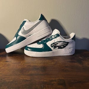 May include: A set of three ceramic mugs with a speckled, matte finish. The mugs are in shades of cream, light gray, and dark gray. Each mug has a simple, minimalist design, perfect for coffee or tea.