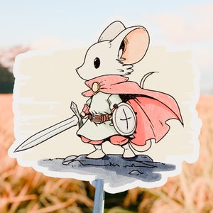 May include: A white mouse wearing a red cape and holding a sword and shield. The mouse is standing on a rock with a light brown background.