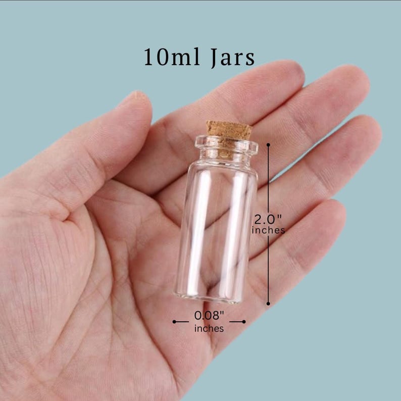 May include: A clear glass jar with a cork stopper, labeled 10ml Jars. The jar measures 2.0 inches in height and 0.08 inches in width, as indicated by the visible measurement lines and text printed on the image.