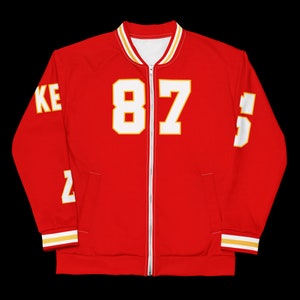 Puede incluir: Chaqueta de b&eacute;isbol roja y blanca con el n&uacute;mero "87" en la parte delantera y la palabra "Chiefs" en la manga.