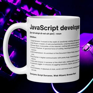 May include: White ceramic mug with a black handle. The mug has a black and white graphic with the text "JavaScript developer" and a definition of the term. The definition includes synonyms: "Script Sorcerer, Web Wizard, Browser Bard".