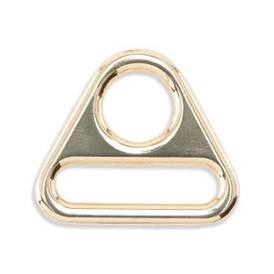 May include: Gold-toned metal triangle-shaped ring with a large oval opening and a smaller rectangular opening.