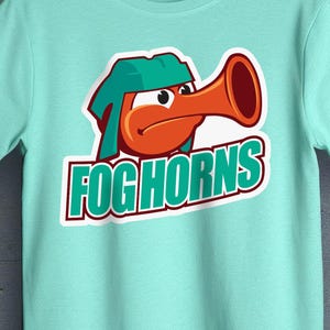 May include: A turquoise t-shirt with a cartoon character wearing a green hat and blowing a red horn. The text "FOGHORNS" is printed in white on a green banner.