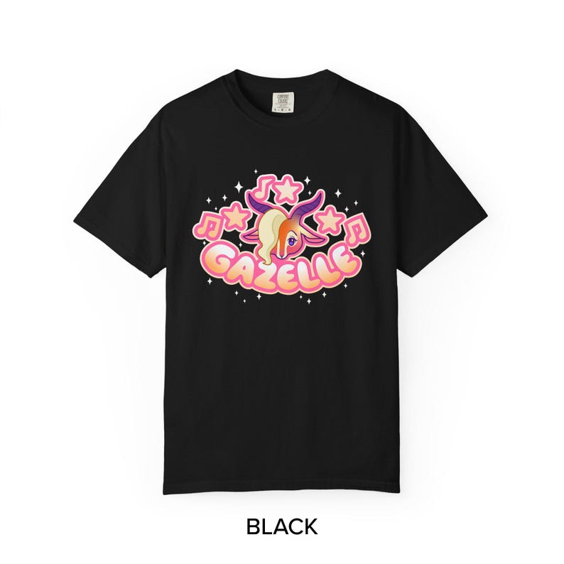 May include: Black t-shirt featuring a cartoon gazelle with musical notes and stars. The word "Gazelle" is written in a bubble font. The gazelle has blonde hair and purple horns. The word "BLACK" is written at the bottom.