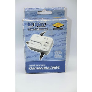 May include: A white RF unit with a black cable and a white box. The box is labeled "RF Unit Auto RF Switch" and "Compatible with Gamecube/N64".